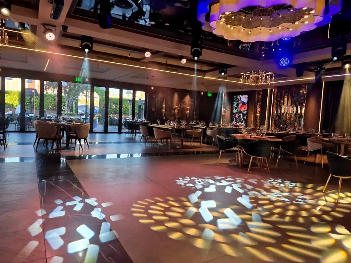 A long table arranged for an evening celebration at Lē Brand