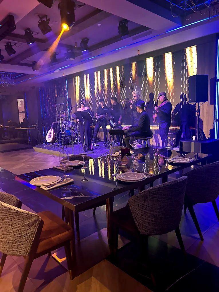 Live musicians performing on the Lē Brand stage