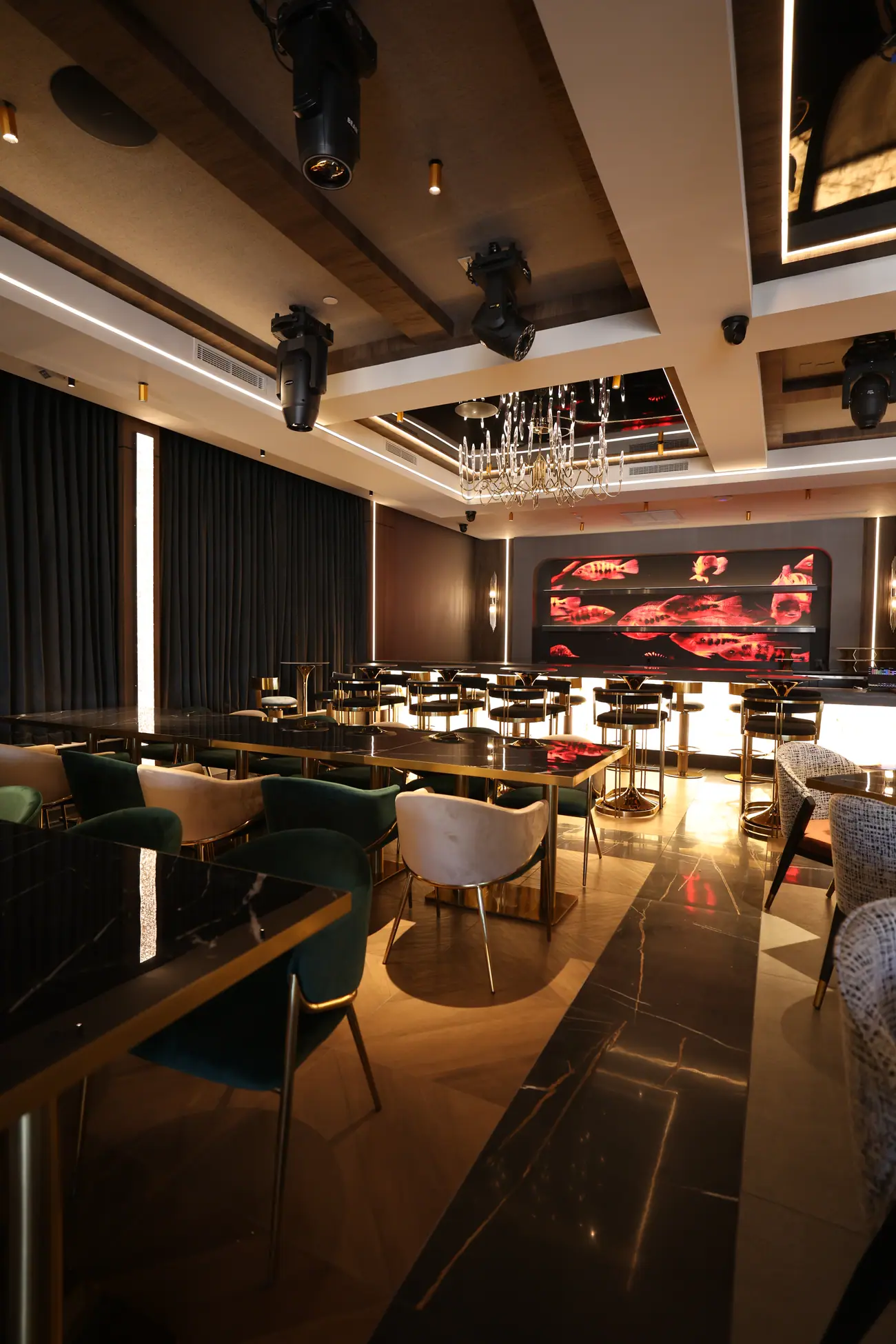 An intimate dining setting with artwork and a sculptural ceiling light